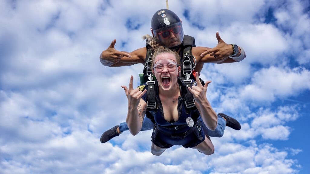 female tandem skydiving student having fun in freefall at Skydive DeLand