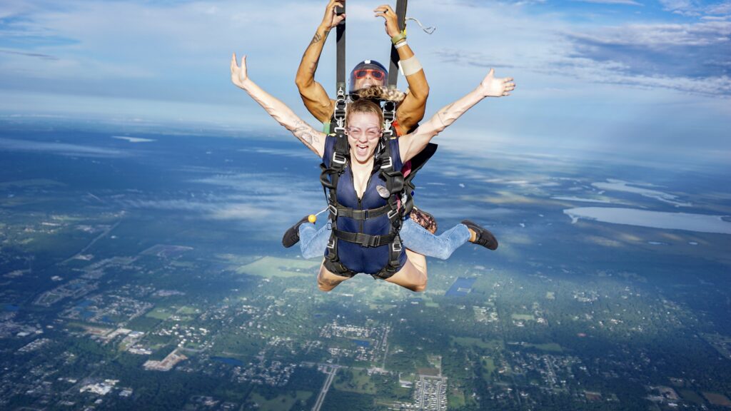 tandem skydiving pair as parachute opens in DeLand, Florida