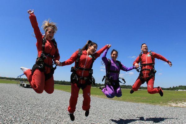 tandem skydiving students celebrate after skydiving at DeLand, Florida