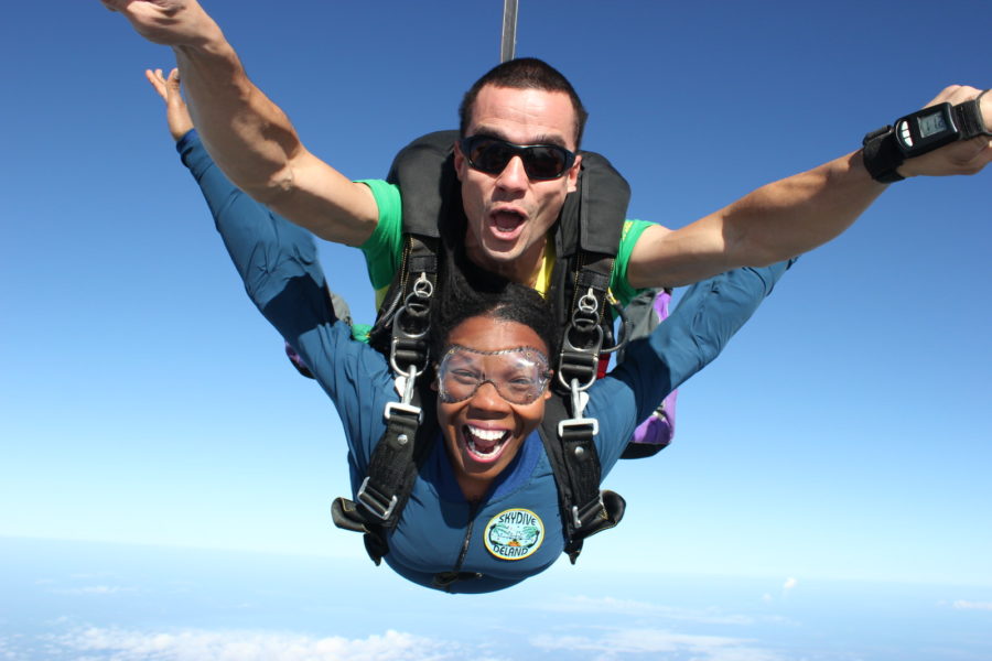woman grins ear-to-ear in skydiving freefall at Skydive DeLand
