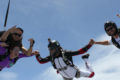 tandem skydiving student safely enjoys freefall attached to instructor